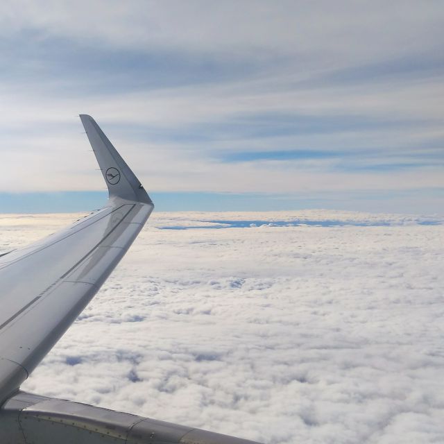 Foto aus dem Flugzeug vom Flugzeugträger über den Wolken