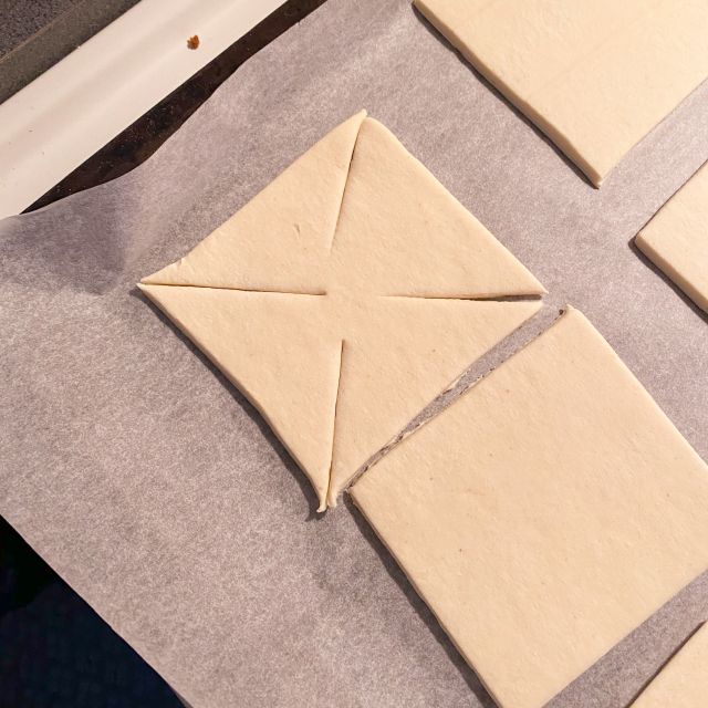 Quadrate aus Blätterteig mit eingeschnittenen Ecken